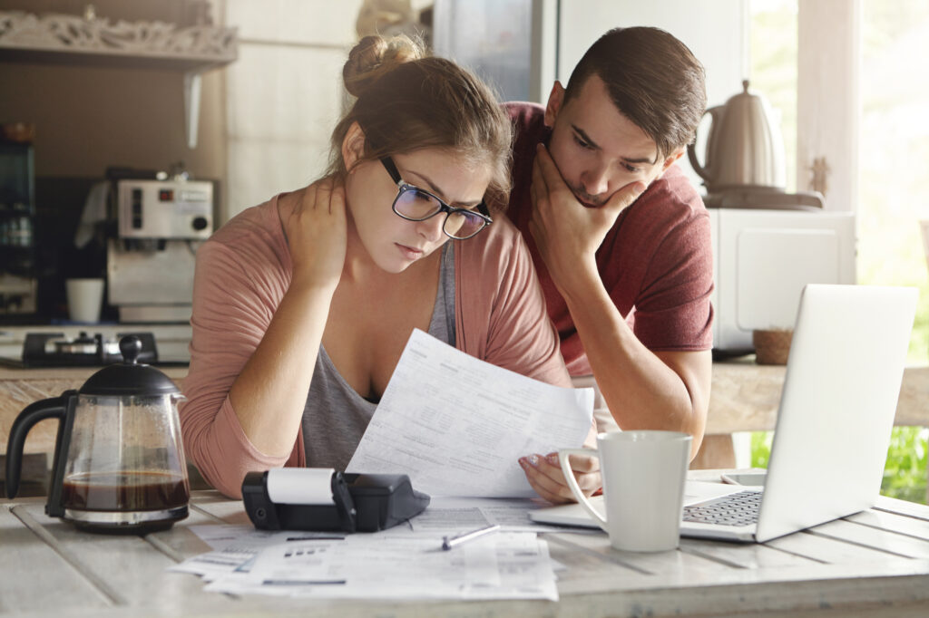 A couple looking at their finances to decide what to do next.